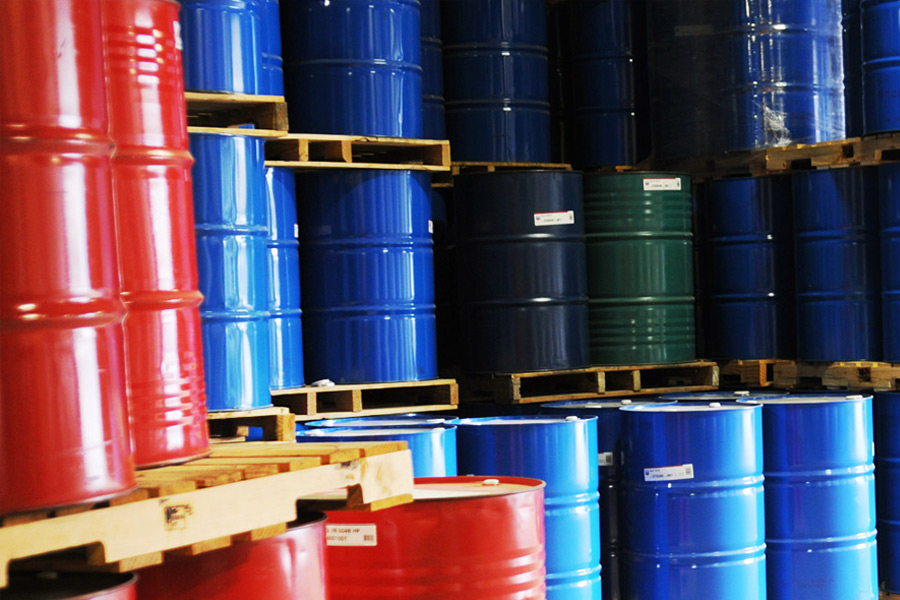 Oil canisters in different colors stacked next to each other.